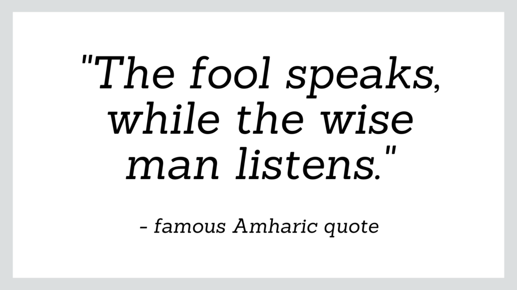 Famous Amharic quote about life which reads 'the fool speaks, while the wise man listens'.